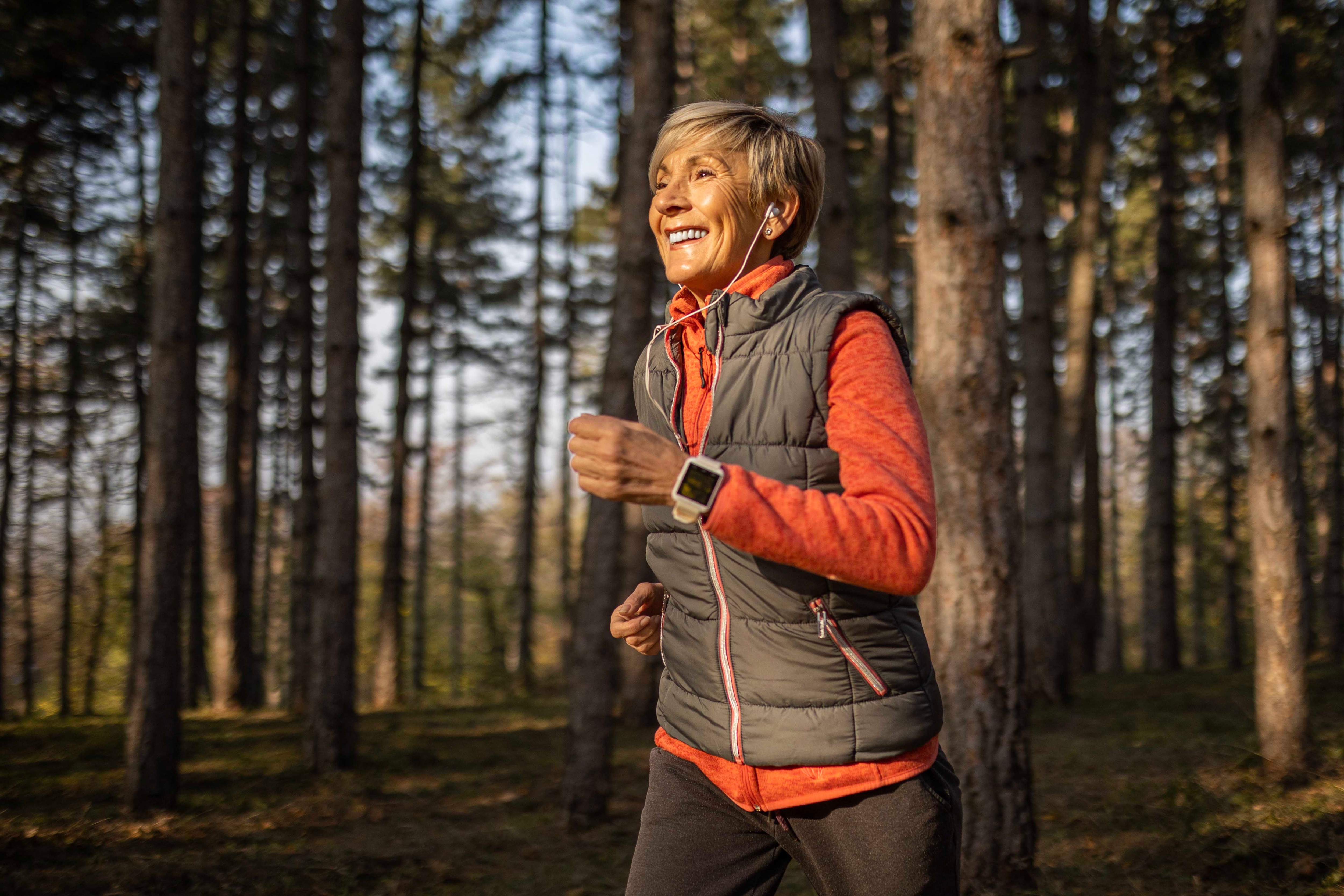 Woman running on a trail in a forrest