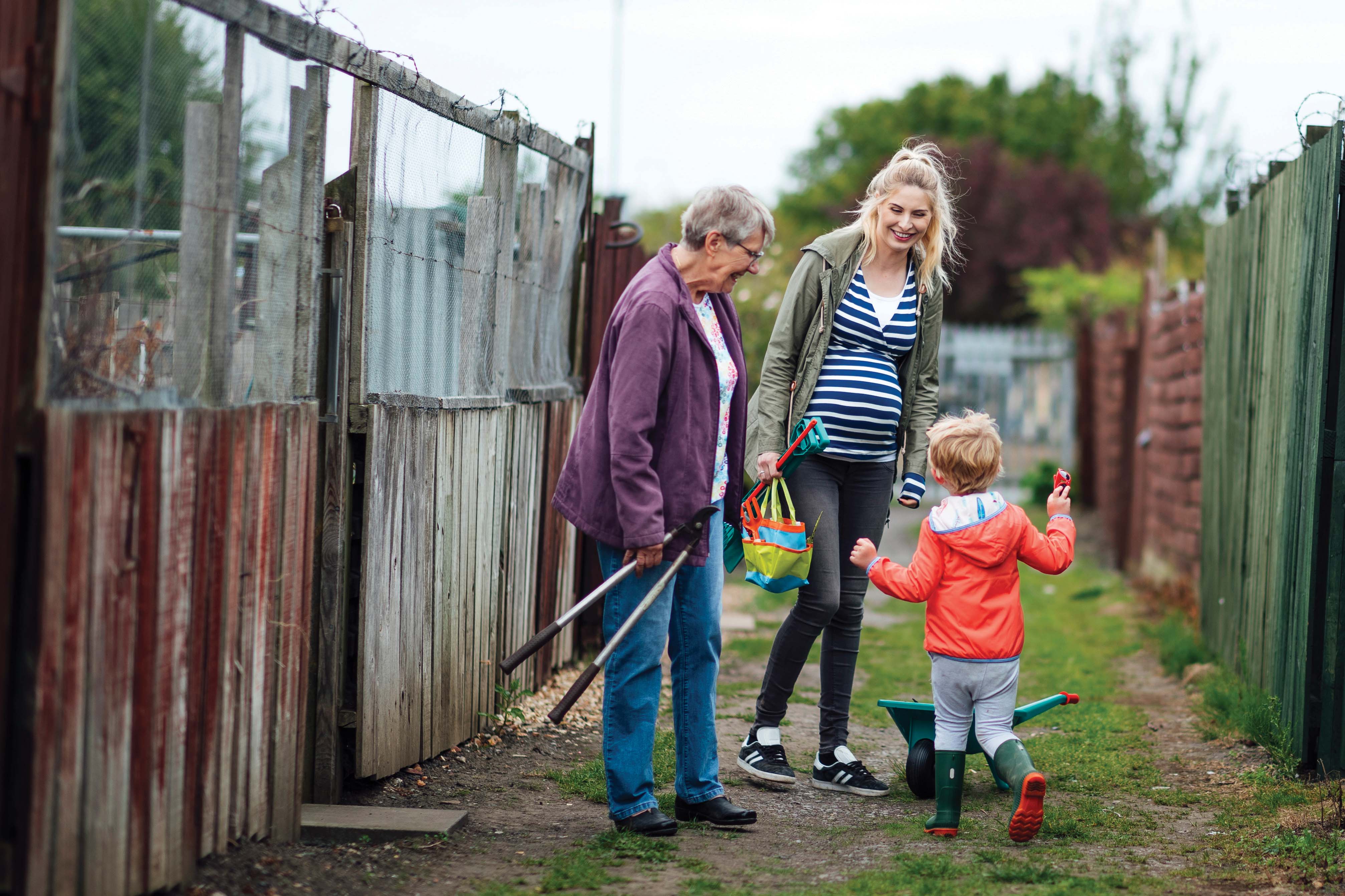 Grandmother, Mother, and Child playing outdoors